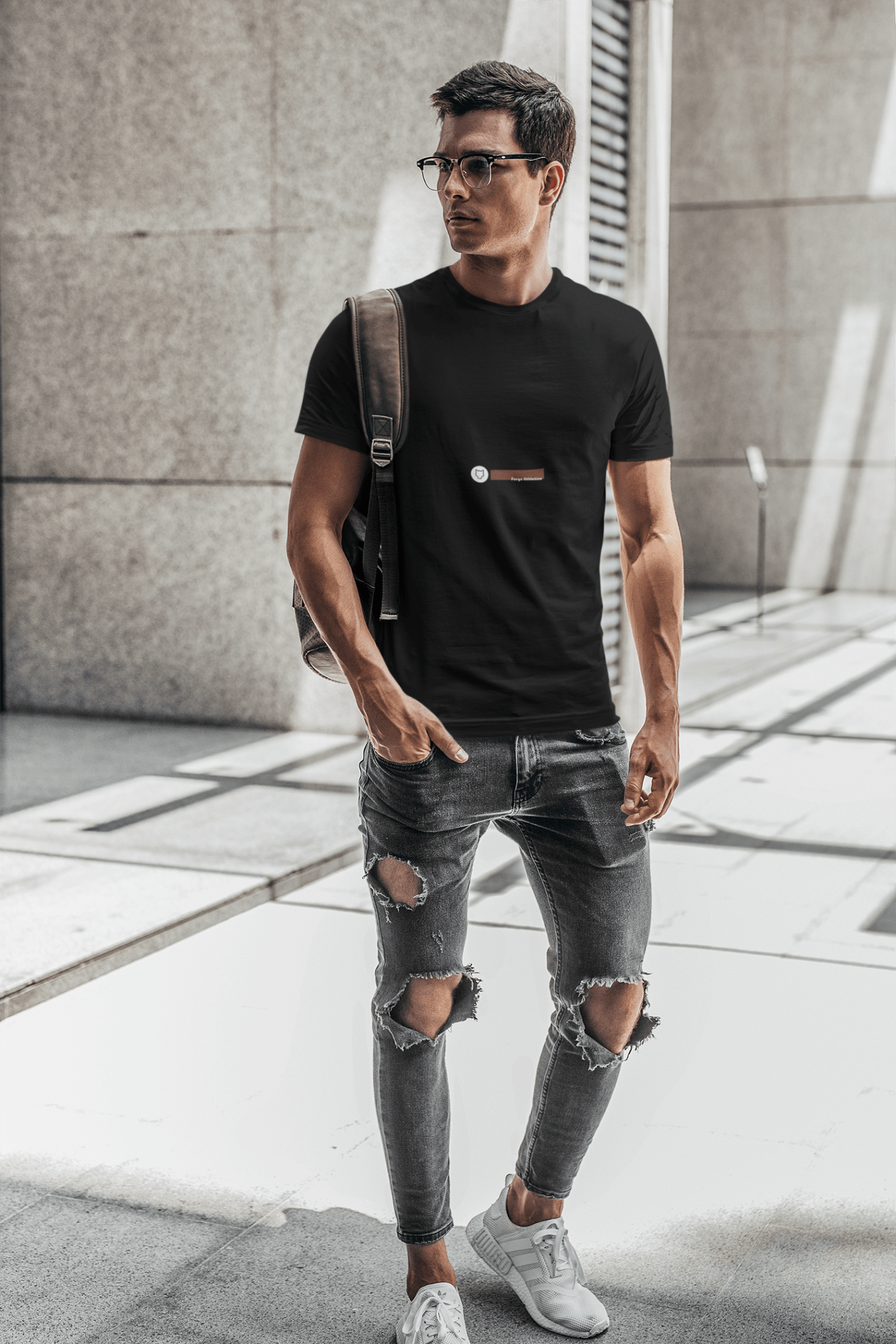 Man wearing a Minimalistic black T-shirt with a classic round neck, showcasing timeless elegance and versatile style.