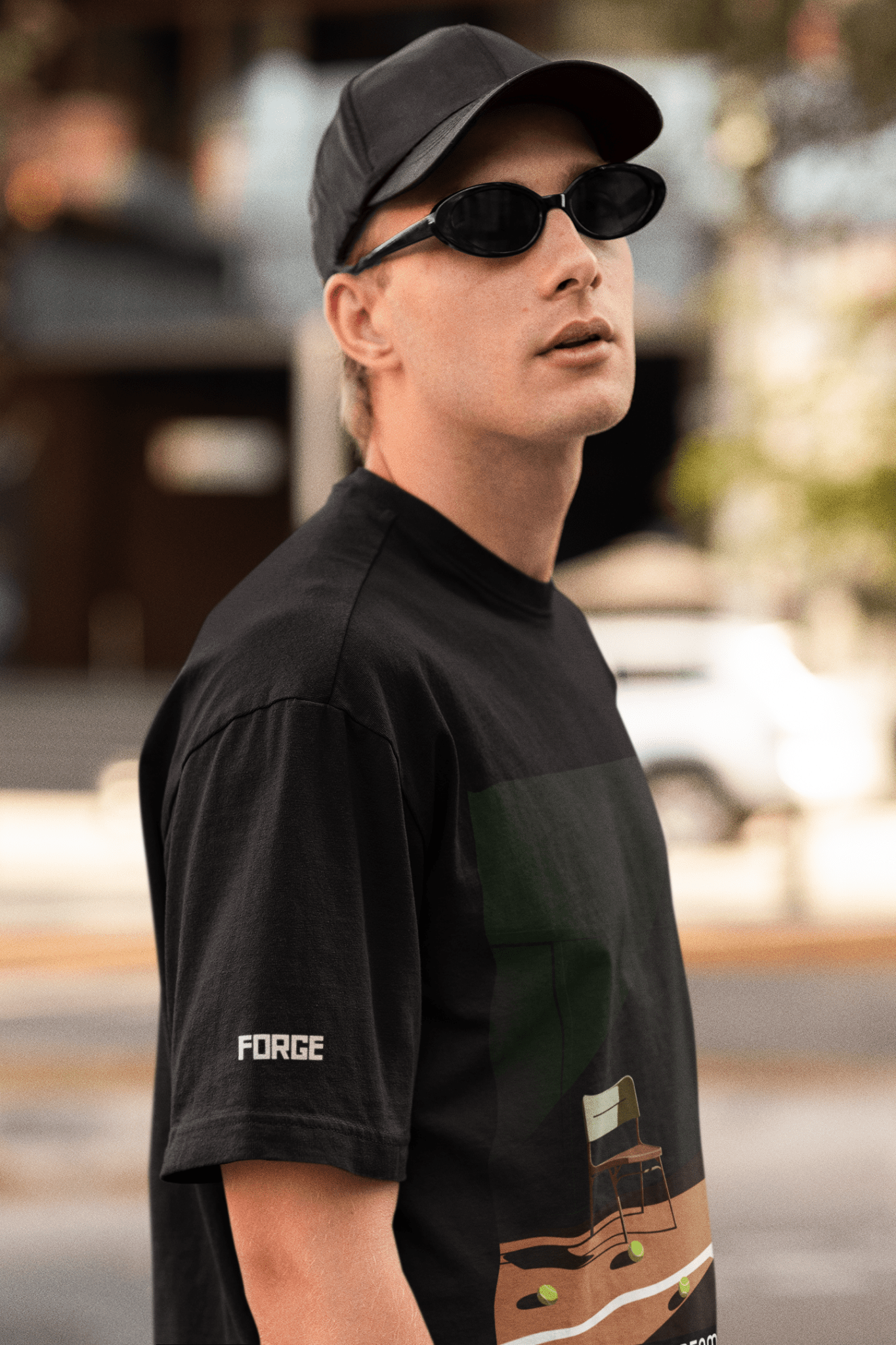 Side view of black casual t-shirt worn by a white man along with black sunglasses.